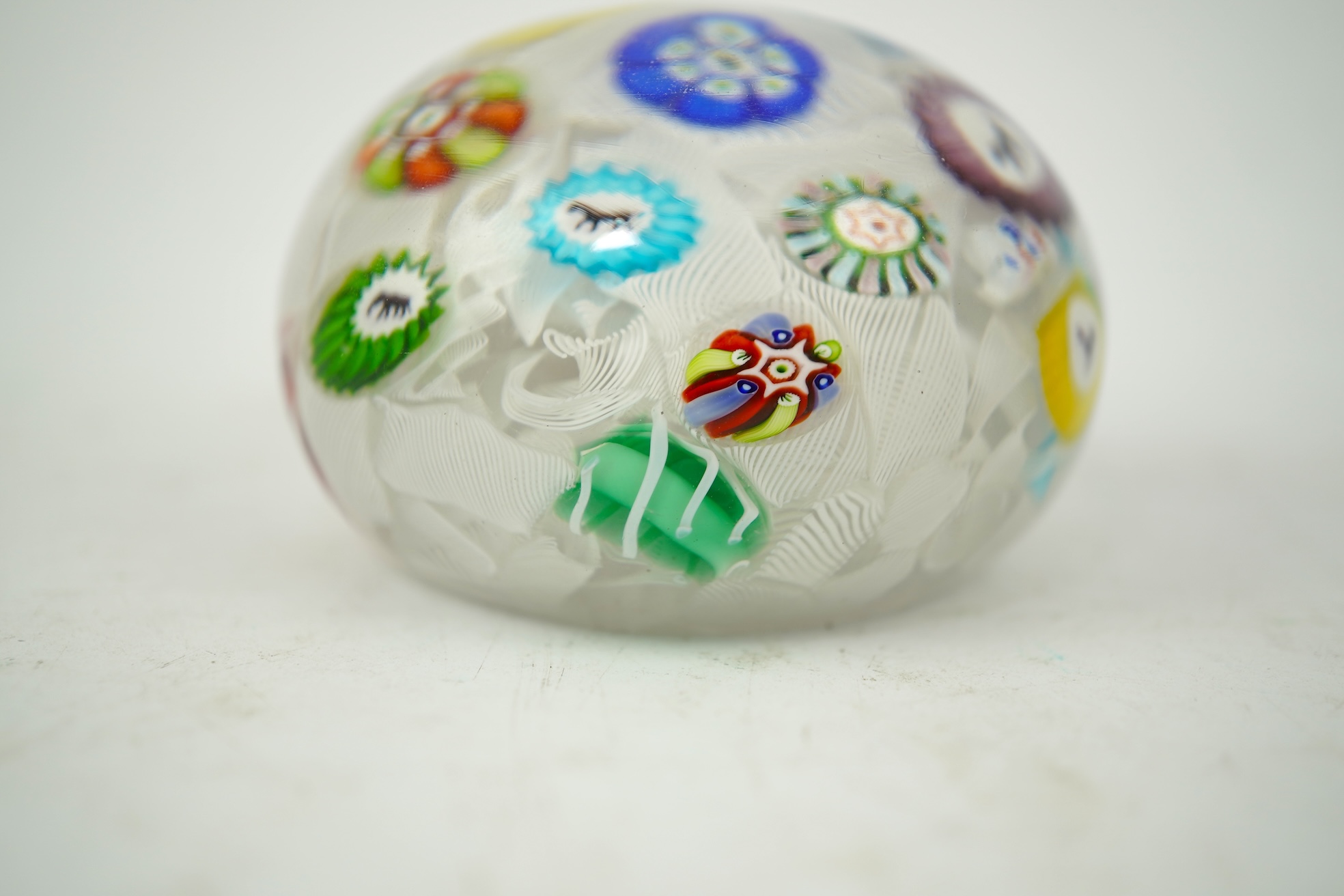 A Baccarat silhouette cane upset muslin ground paperweight, one cane dated 1848